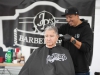 San Marcos resident Mike Stansbury gets a haircut by JR of JR's Barber Shop at the San Marcos Spring Festival on April 10. The festival, in it's 24th year, was held on Via Vera Crus in San Marcos and had entertainment, games for kids as well as food and merchandise vendors. Stephen Davis/The Telescope