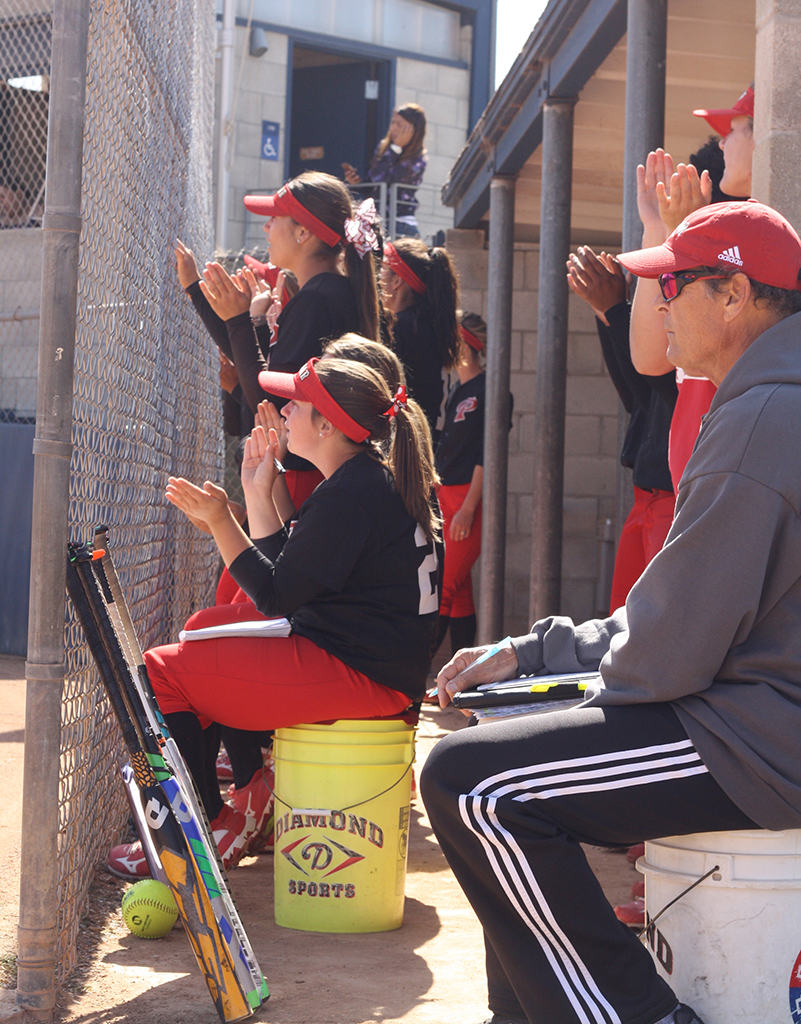Palomar college softball players cheer each other on
