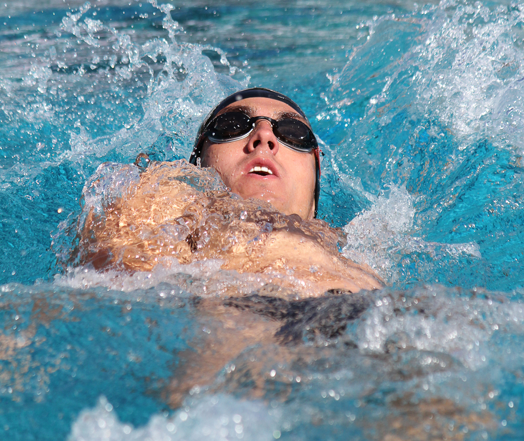 Conner Baine swims the men’s 200-yard backstroke at the swim meet between Palomar and Grossmont on March 17 at the Wallace Memorial Pool. Baines placed first with a time of 2:11.37 but the men lost the meet overall with a score of 136.5 - 103.5. Coleen Burnham/ The Telescope