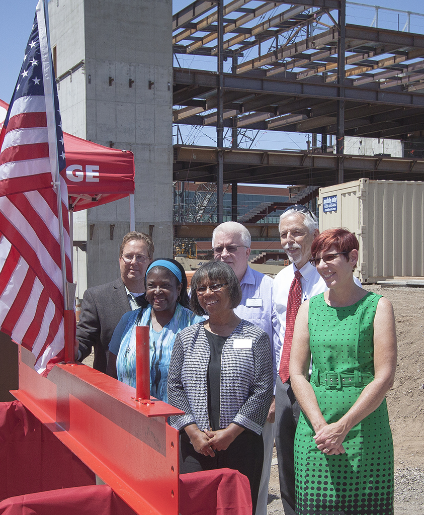 Palomar College Superintendent/President Dr. Joi Lin Blake (3rd from left) and members of the Palomar College faculty pose prior to signing the Library/Learning Resource Center top beam on July 28. Following signing of the beam by attendees at the ceremony it was hoisted up and bolted into position onto the structure. Stephen Davis/The Telescope