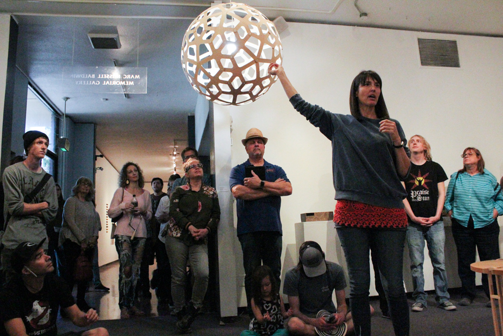 Jennifer Anderson speaks about the round lamp at the Boehm Gallery on April 5. Belen De Anda /The Telescope