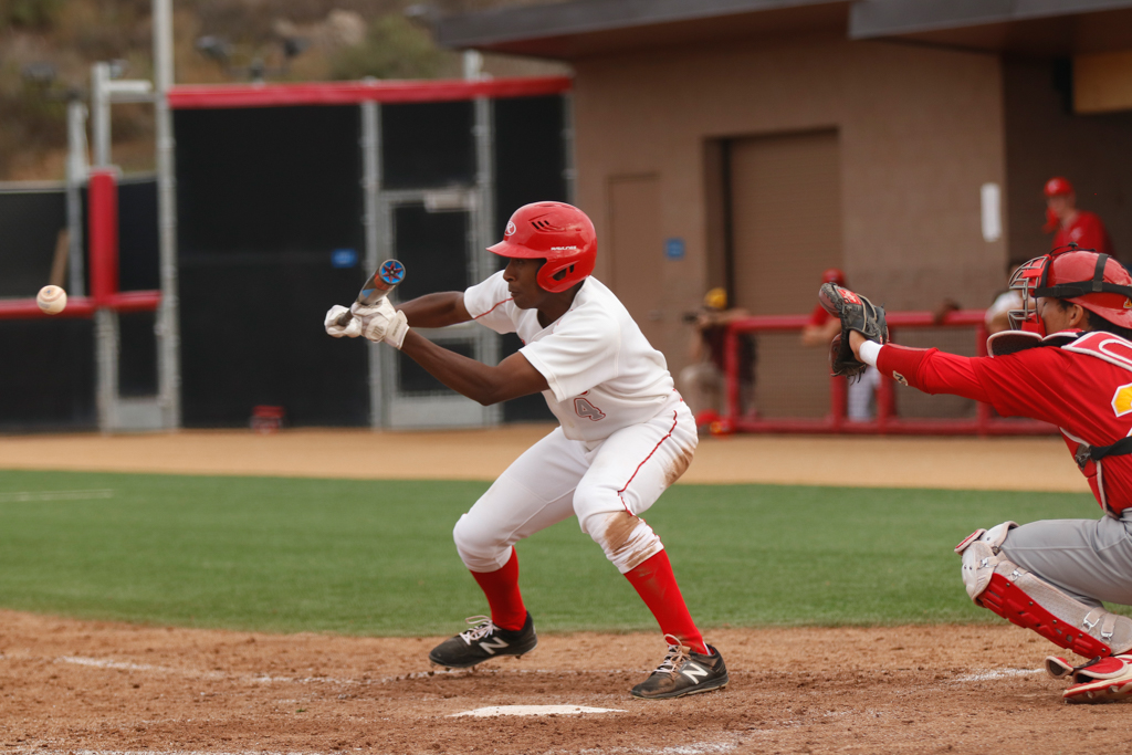 Late in the home game against College of the Desert, Eric Charles bunts the ball at home plate, when the first baseman misses the ball he has time to run all the way to third base, March 8, 2018. Eddie Hoffman / The Telescope