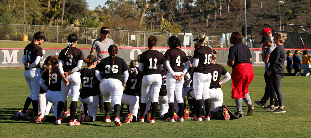 Palomar softball head coach, Lacey Craft, talks to the team after they’re win against Fullerton on Feb. 16. The final score was 1-0. Amanda Raines/The Telescope