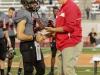 November 22, 2014 | Palomar quarterback #2 Mitch Bartram accepts the Most Valuable Player award from Palomar Athletic Director Scott Cathcart. Bartram finished the game with 222 yards passing and a touchdown, he also rushed for 31yards. The Comets went on to defeat the Vaqueros 30-22 and win the Patriotic Bowl at Escondido HS, in Escondido California. Photo: Philip Farry | The Telescope