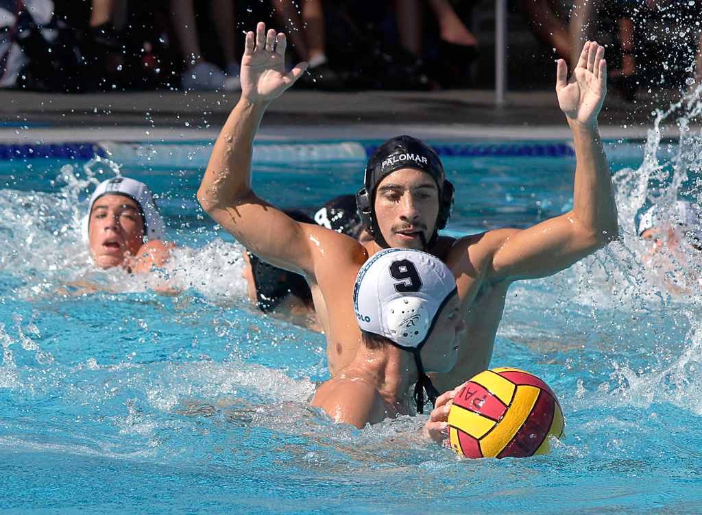 Palomar's Conner Chanove (4) plays solid defence agianst Miramar's Tristan Williamson (9) during the Men's Water Polo PCAC Conference game between Palomar and Miramar on Nov. 4 at the Ned Baumer Pool. Jeff Burr (8) looks on from back. Palomar men won 22-12. Coleen Burnham/The Telescope