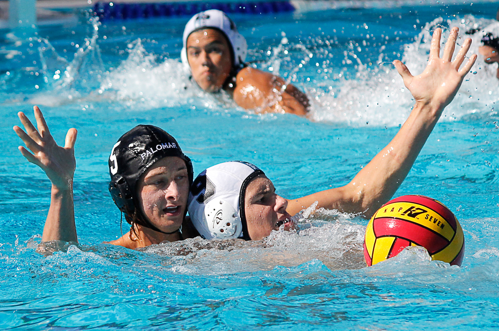 Palomar's Paul Schaner (5) wrestles with Miramar's Tristan Williamson (9) during the Men's Water Polo PCAC Conference game between Palomar and Miramar on Nov. 4 at the Ned Baumer Pool. Palomar men won 22-12. Coleen Burnham/The Telescope