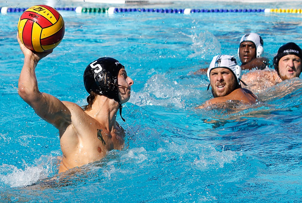 Palomar's Paul Schaner (5) scores goal nine for the Comets during the Men's Water Polo PCAC Conference game between Palomar and Miramar on Nov. 4 at the Ned Baumer Pool. Miramar's Josh Collett (4), Akhil Perimbeti (6) and Palomar's Tristan D'Ambrosi (2) look on from the side. Palomar men won 22-12. Coleen Burnham/The Telescope