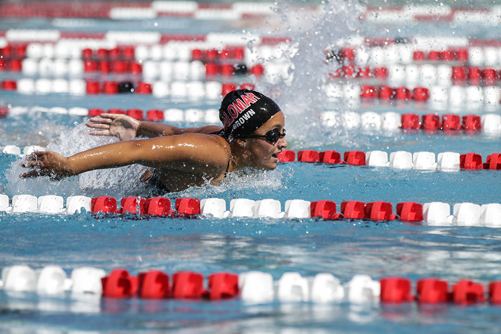 Palomar’s Morgan Brown swims the 100 yard butterfly, she won her heat with a time of 1:07 to advance to the finals of the PCAC Championships held April 17 at the Wallace Memorial Pool. Philip Farry / The Telescope.