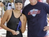 Palomar’s Paulina Dehaan (L) won the 100 yard butterfly in a time of 1:00. Palomar Swim Coach Jem McAdams (R) presented Dehaan with her first place medal April 17 at the Wallace Memorial Pool. Philip Farry / The Telescope.