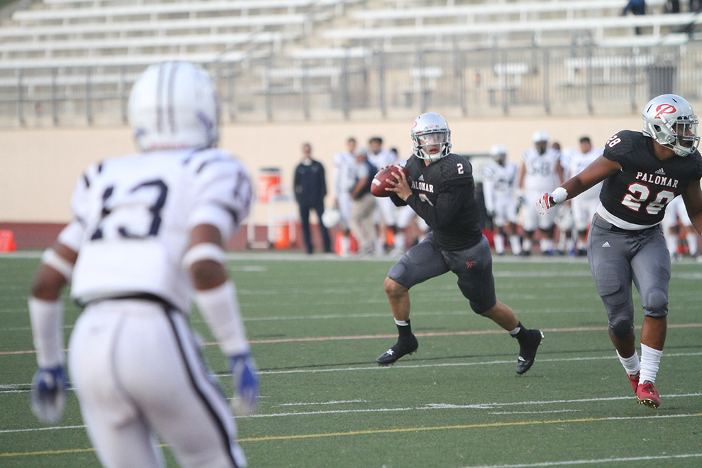 Quarterback Matt Romero looks for an opening to pass the ball during the beginning of Palomar's first homegame at Escondido High School on Sept. 16. This play put the Comets in position to score the first field goal of the game. The final score 6-37 in favor of Cerritos.