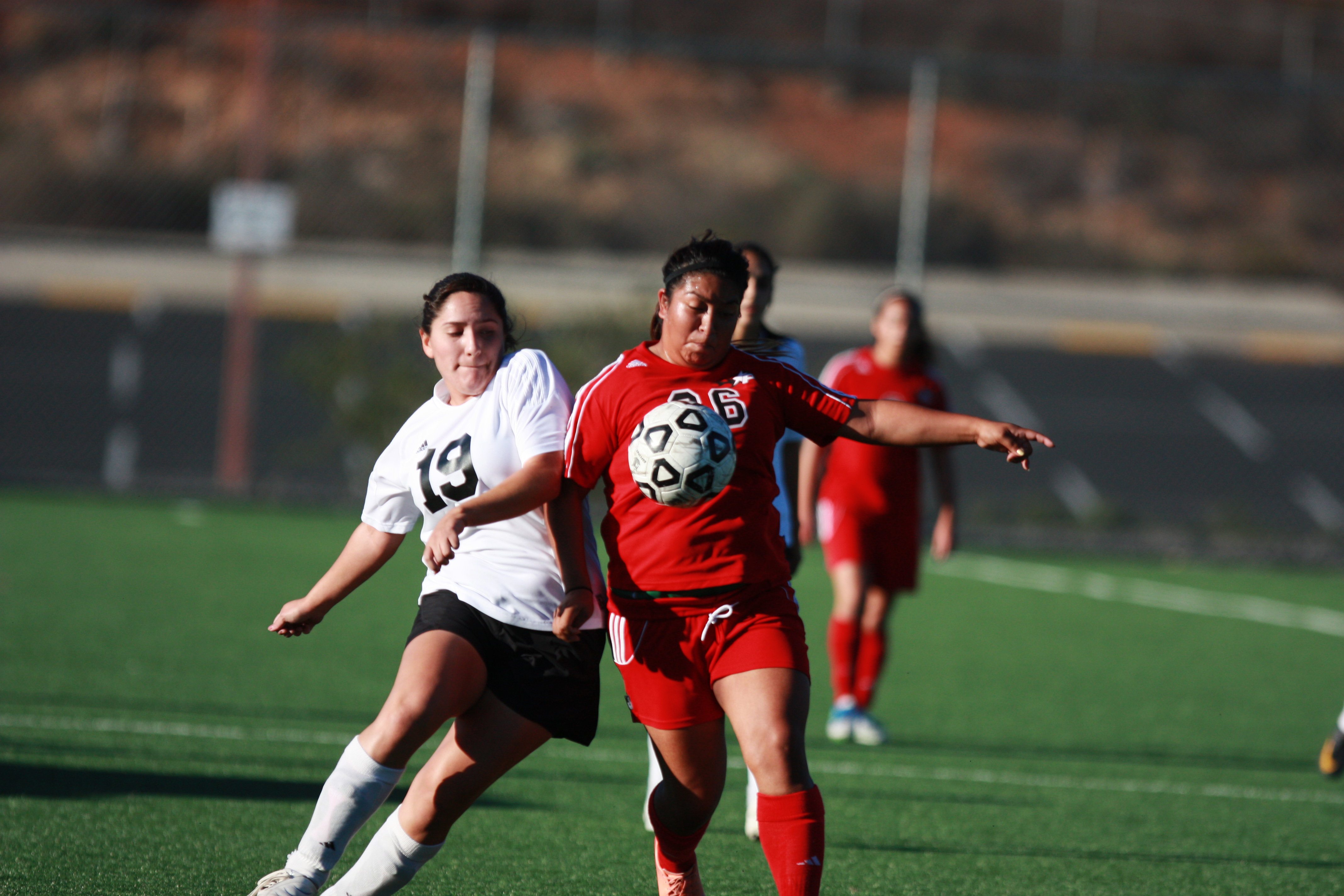 Midfielder Julie Molina (#26) tries to get to the ball before her opponent from Imperial Valley College can get to it in a women's soccer game at Minkhoff Field. The Comets pulled off an impressive 4-0 win against The Arabs. • Scott Colson/Telescope