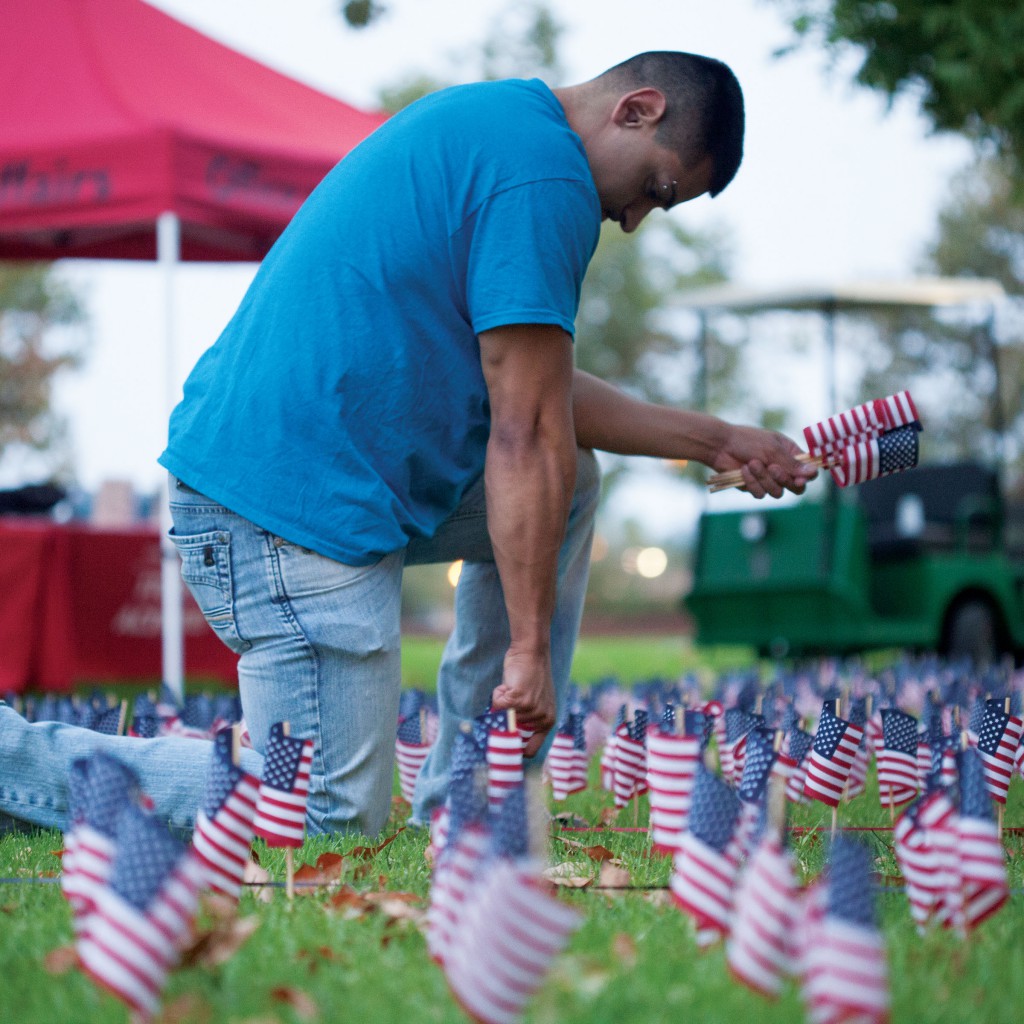 Palomar College student and U.S. Marine Corps Veteran, Camilo Osuna assists in placing US flags in remembrance of 9-11 on Sept. 11, 2013. Stephen Davis/Telescope File Photo