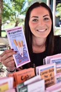 Kori Moya of Vista Community Clinic displays information about the status of different cigarettes currently available on the San Marcos campus for the Great American Smoke Out on Nov. 14. • Lucy Wheeler/Telescope