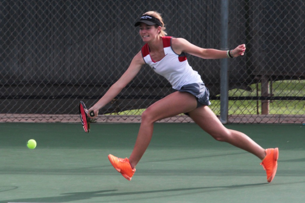 Palomar women's tennis player jumps to hit a forehand against Irvine Valley College on Feb 11 at Palomar's tennis courts. Joe Davis/The Telescope