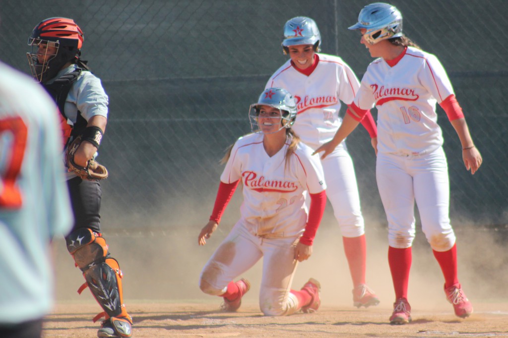 Palomar shortstop Kali Pugh celebrates with outfielder Keilani ‘KK’ Fronda and first baseman Paige Falconeiri after scoring on designated hitter Carlie Daniel’s RBI double against Riverside City College on April 15 at Palomar’s softball field.  Pugh went 3-4 with an RBI in the Comets’ 9-4 win over the Tigers in a rematch of the 2013 state title game when Palomar brought home a championship with a 7-2 win. Scott Colson/The Telescope