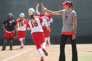 Palomar head softball coach Lacey Craft waves in base runners Carlie Daniel and Paige Falconeiri on Kristina Carbajal’s RBI double in the 3rd inning to put Palomar up 15-0 against Imperial Valley College on April 23 at Palomar’s softball field. The Comets’ offense scored a season high 25 runs, in part to a combined 5 home runs and 15 RBI’s from outfielder Keilani ‘KK’ Fronda and third baseman Maci Lerno, and perfect pitching performances from Dani Cowan, Maci Lerno, and Kristina Carbajal. The 25-0 win over the Arabs gave the Comet’s a perfect 18-0 conference record for the first time since 2005. Scott Colson/The Telescope