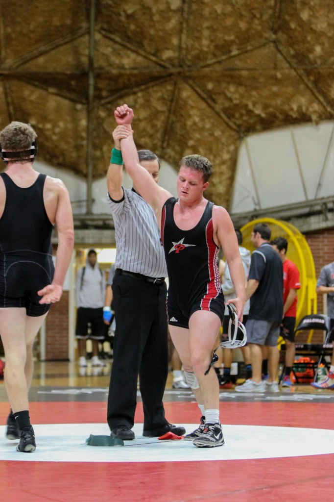 October 15, 2014 | Palomar College wrestler Erik Collins (right) raises his hand in victory over Mt. San Antonio College Zachary Mitchell (Left). Collins won the match 4-3.  The Mounties won the overall match 26-14, which took place at The Dome at Palomar College. Photo:  Philip Farry/The Telescope