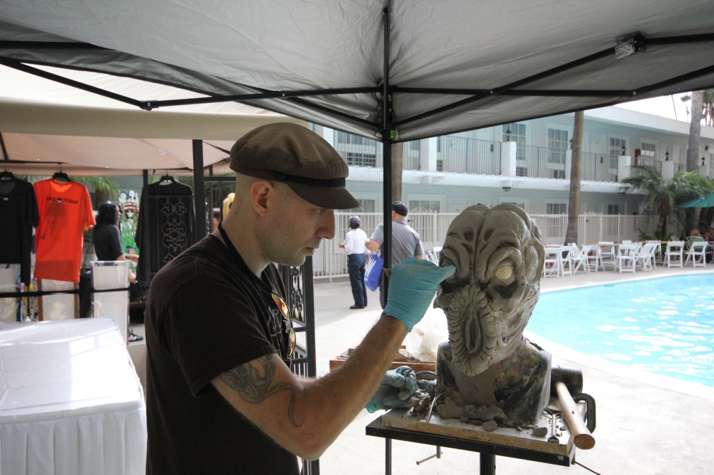 Clay sculptor Jason Hite working on an alien head sculpture named Ascaras at Comic Fest October 19, 2014. Photograph by Dirk Callum