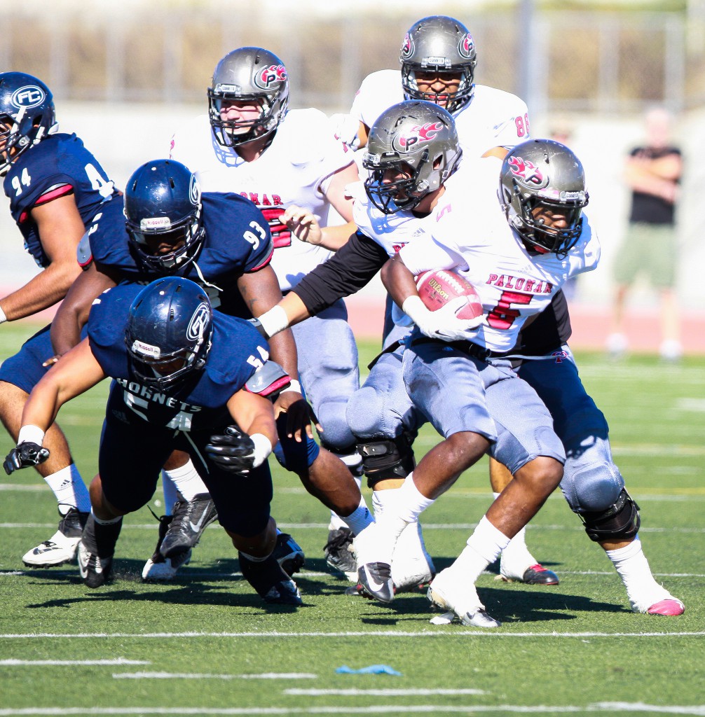 Palomar Running Back Justin Harris eludes Fullerton College tacklers during 1st quarter action at Nathan Shapell Memorial Stadium on 8 Nov. Harris would finish with 64 yards on 20 carrys in the 38-17 loss against the Hornets. Photo courtesy Stephen Davis. 