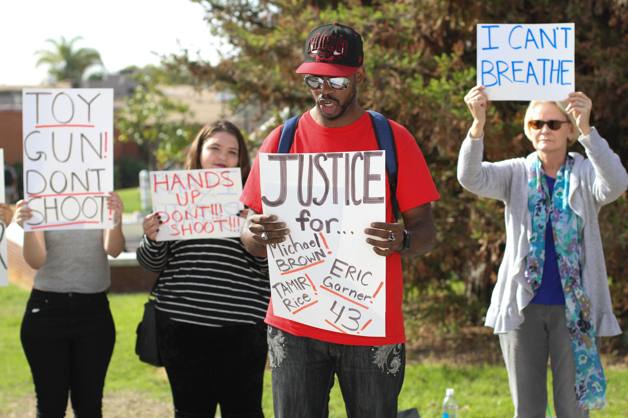 (l-r) Palomar Students Cheyenne Bartram, Christopher Walker and Barb Kelber hold signs and chant slogans at a demonstration on the Palomar College Campus on Dec. 10, 2014. The students gathered to protest against police brutality. (Telescope Staff/The Telescope)