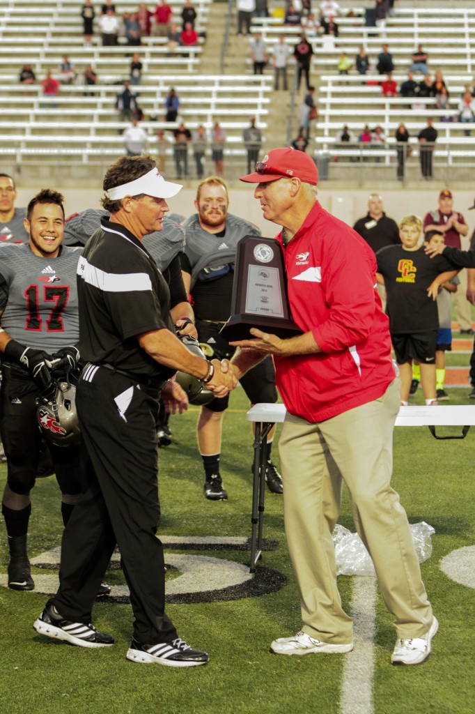 November 22, 2014 |Palomar Athletic Director Scott Cathcart presents Palomar Head Football Coach Joe Early with the Patriotic bowl trophy. The Comets defeated the Vaqueros 30-22 and win the Patriotic Bowl at Escondido HS, in Escondido California.| Photo Credit: Philip Farry | The Telescope