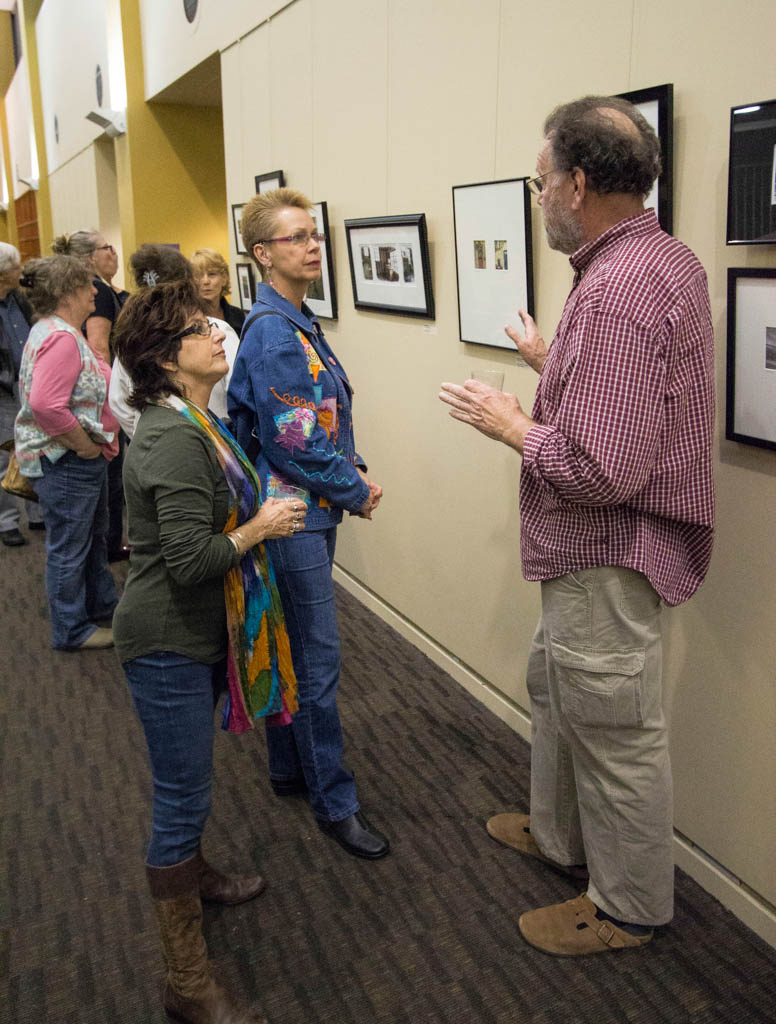 Palomar Photography Professor Robert Barry (r) discusses a photograph on display Jan. 23, 2015 at the Hearth Gallery in the San Marcos Community Center with Dean Norma Miyamoto (c) and Photography Professor Donna Cosentino. The photography exhibit consists of photographic works by students in the Palomar College Photography Program and will be on display at the Community Center until end of February. (Paul Nelson/The Telescope)