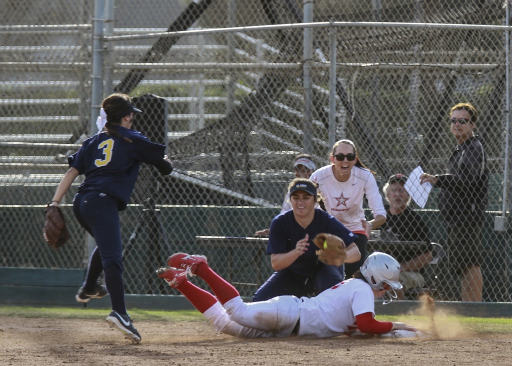 February 11, 2015 | Palomar softball player Kali Pugh (23) dives into third base, beating the throw of Mesa third baseman Kourtney Aimalefoa during the fourth inning. Pugh had two doubles and two RBIs for Palomar. Photo by Philip Farry / The Telescope