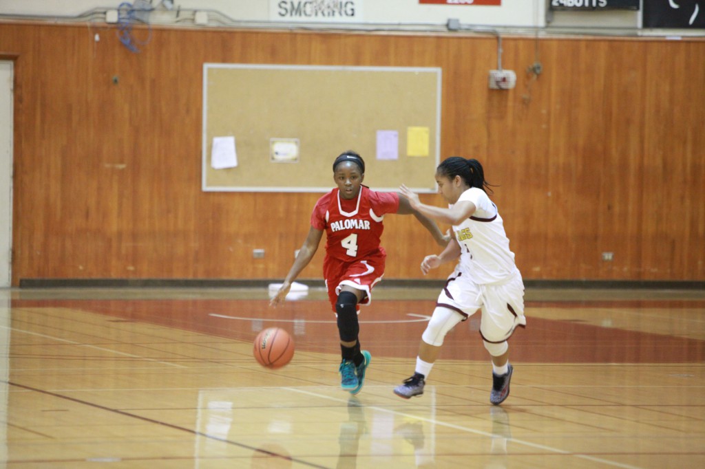 January 7, 2015. Palomar Guard Lee Lee Tomlinson dribbles up the court against Southwestern defender Taylor Smalley during the second half of Pacific Coast Athletic Conference women's basketball game at Southwestern College. Palomar won 76-68. Stephen Davis/The Telescope
