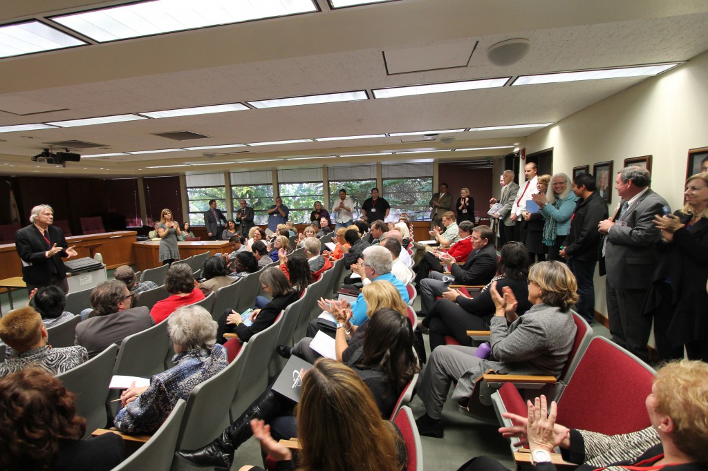 The room of administrators, faculty and staff applaud the educational accomplishments of Mario Gaspar, Associated Student Government President, in the midst of an open College Forum held by a visiting accreditation team in the Governing Board Room, March 3. Justin Sumstine/ The Telescope