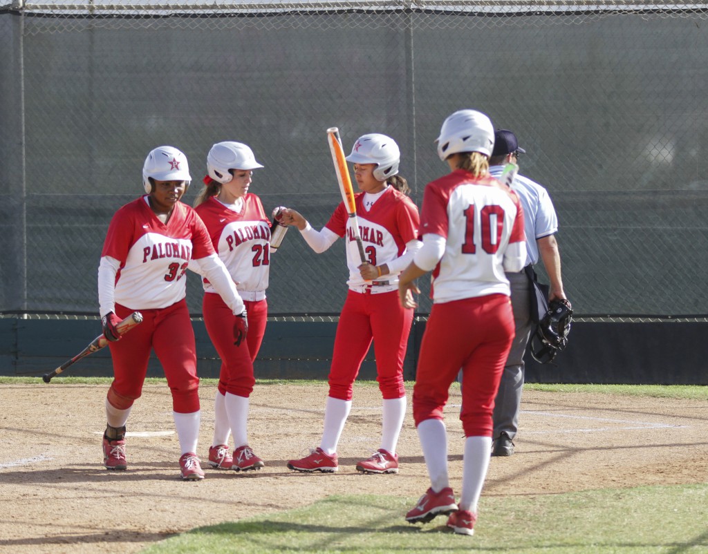 Palomar players (l-r) Iesha Hill, Leah Gordon, Amanda Miller, and Kristina Carbajal celebrate after Hill and Gordon score in the fourth inning against Southwestern College on March 18. The Comets ranked number 2 in the state beat the Jaguars 18-4 in five innings of play at home. The win improved the Comets record to 18-1-1 (10-0 in PCAC). Philip Farry / The Telescope.