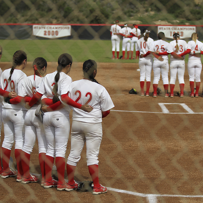The Comets softball team takes the field during the playing of the National Anthem March 11, 2015. (Philip Farry/The Telescope)