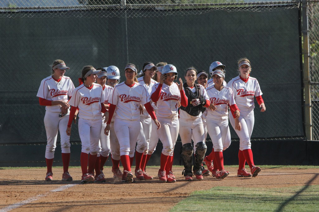 The Palomar Women's Softball team wait at home base for team-mate Brooke Huddleson (4) to congratulate her on the home run hit that resulted in 3 points for Palomar agaisnt Mt. San Antonio, April 4th. Palomar had previously beaten Santiago Canyon College during their first double header game 5-2, and came out on top of Mt. San Antonio 4-1. Dirk Callum/The Telescope