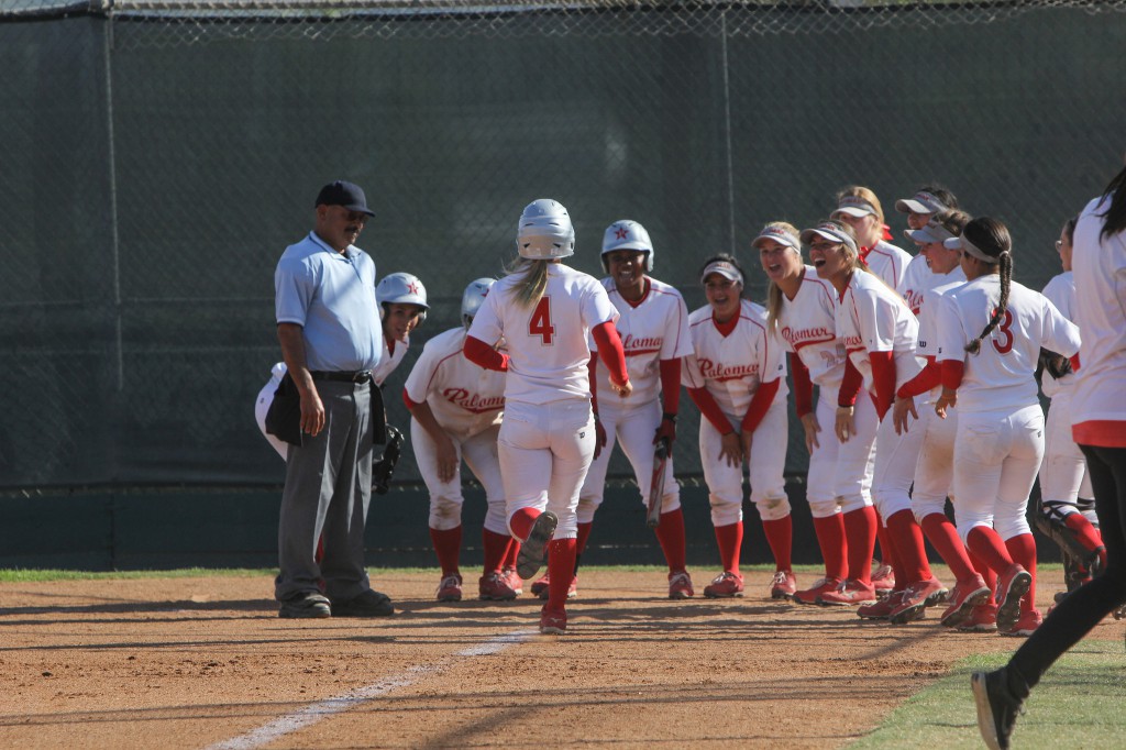 The Palomar Women's Softball team wait at home base for team-mate Brooke Huddleson (4) to congratulate her on the home run hit that resulted in 3 points for Palomar agaisnt Mt. San Antonio, April 4th. Palomar had previously beaten Santiago Canyon College during their first double header game 5-2, and came out on top of Mt. San Antonio 4-1. Dirk Callum/The Telescope