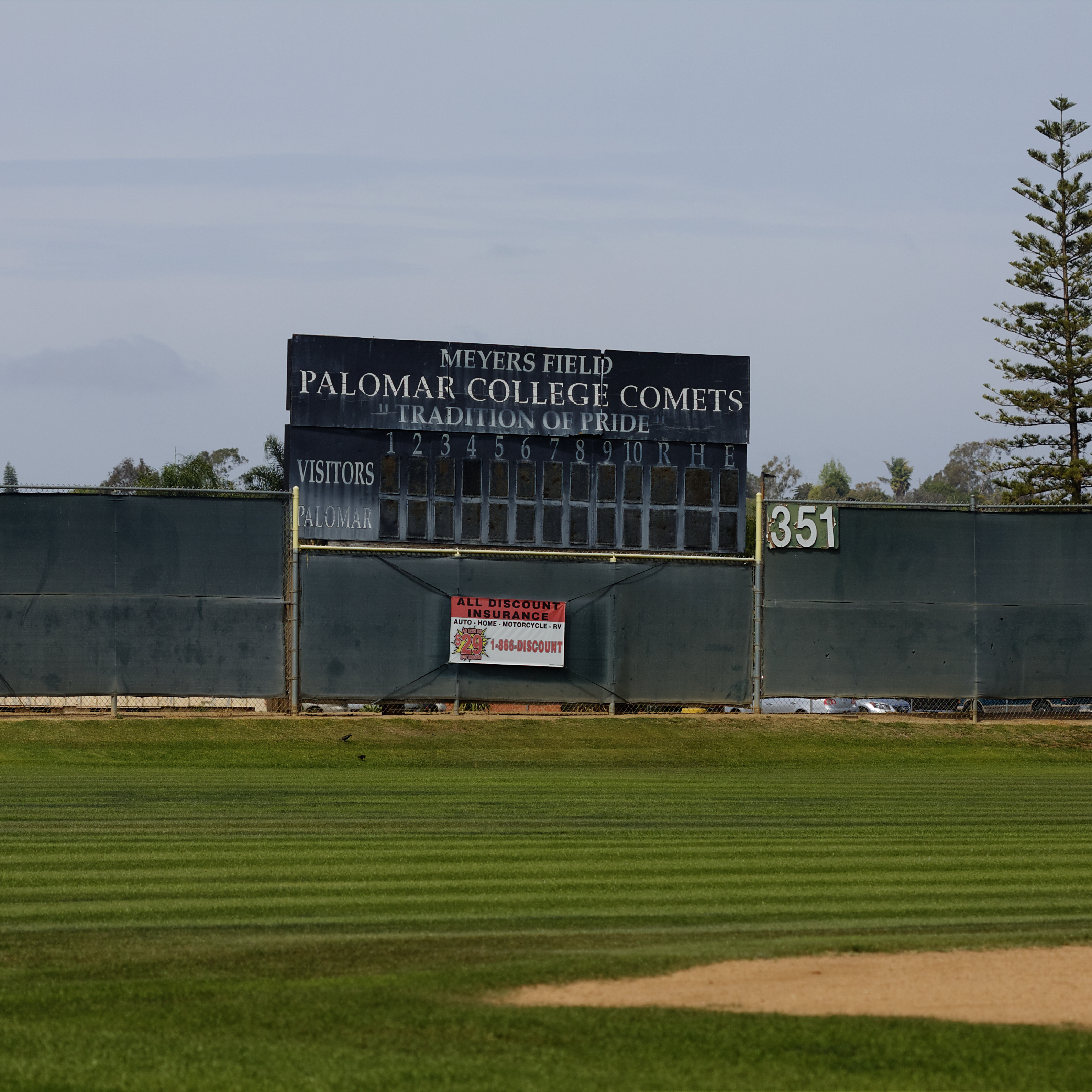 An old Palomar College scoreboard at the baseball field. The text on top of the board reads "MEYER'S FIELD PALOMAR COLLEGE COMETS "TRADITION AND PRIDE."