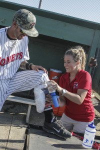 Palomar trainer Amber Gates works on the calf of shortstop Dylan Breault. Philip Farry/ The Telescope.