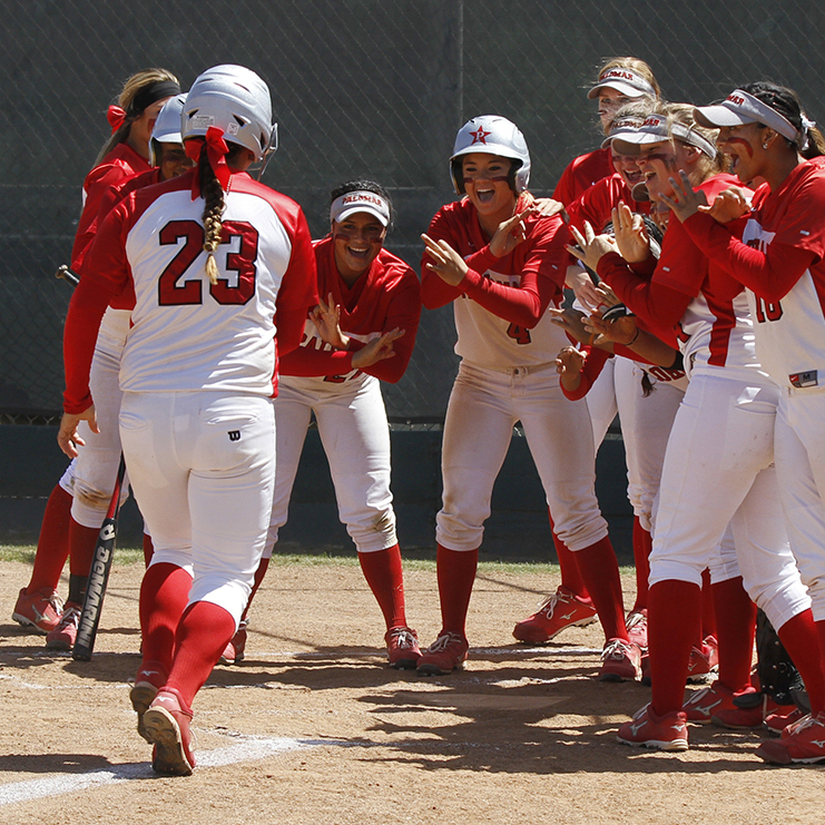 Palomar’s women wait for Kali Pugh after she hit a homerun in the second inning against the #16 ranked Cuesta College. The Comets ranked #1 in the Southern California Region played homerun derby by hitting five in the game and beat the Cougars 13-0 in five innings on May 2, 2015. (Philip Farry/The Telescope)