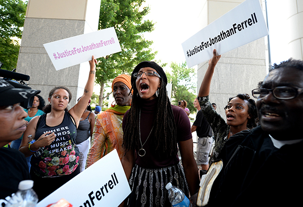 A young woman yells, "black lives matter," with other protesters at the Mecklenburg County Courthouse on Friday, August 21, 2015 protesting when after four days of deliberations, a mistrial was declared when the jury was unable to resolve a deadlock in the case of Randall "Wes" Kerrick in Charlotte, N.C. Kerrick, a Charlotte-Mecklenburg Police officer accused of killing an unarmed man, Jonathan Ferrell, in a struggle two years ago. (Jeff Siner/Charlotte Observer/TNS)