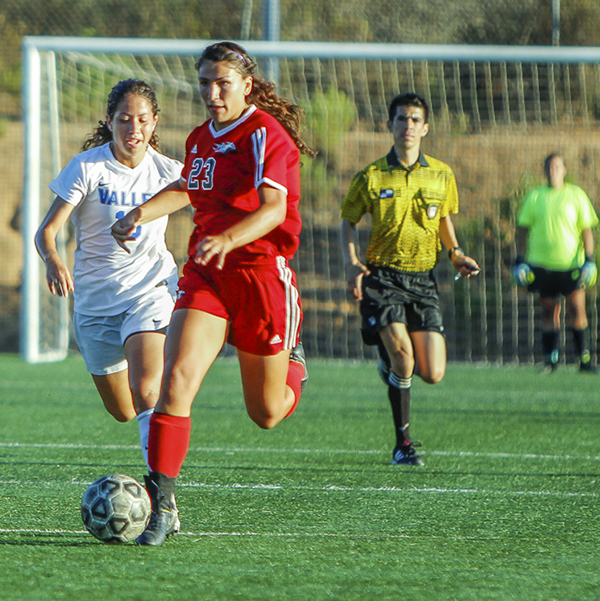 Palomar forward Samantha Swanson dribbles the ball forward while visiting Valley College defender Jenny Guyett tries to attack from behind during Oct. 2 home game on Minkoff Field. Palomar was defeated by Valley 0-6. (Hanadi Cackler/The Telescope)