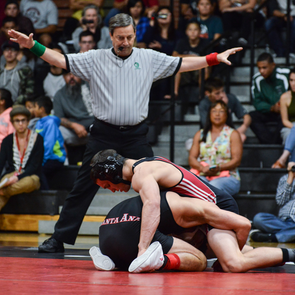Palomar's No. 2 ranked Eric Collin matches up against Santa Ana's Eric Roberts, S at the Dome Oct. 28, 2015. Collin wins his match 10-2 as referee, Randy Hartman officiates. (Brandy Sebastian/The Telescope)