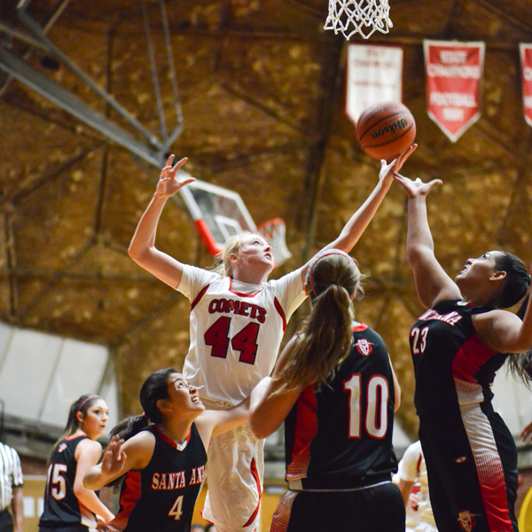 Palomar forward Lynnzy Troxell #44, reaches for a rebound amongst Santa Ana College players, The Dome, Nov. 5. Troxell scores 8 points and leads with 7 rebonds earning the Comets a win 86-60 (1-0). Brandy Sebastian/The Telescope