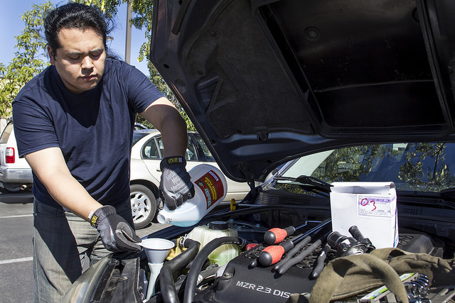 Rodney Figueroa demonstrates the ease and importance of winterizing your car to keep running smooth through the cold season. San Marcos, Calif. Oct. 31, 2015. (Patty Hayton/The Telescope)