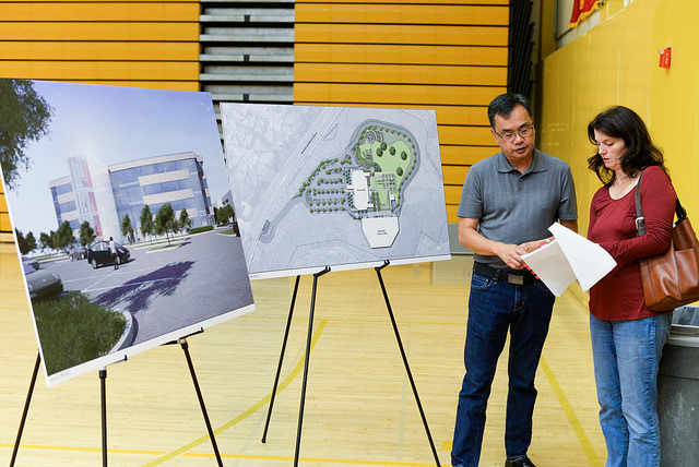 Luke Chen and Sharon Reynolds, residents of Rancho Bernardo, study a copy of an Environmental Impact Report prepared for Palomar College at a community forum held at Mt. Carmel High School on Wednesday, Oct. 28, 2015. (Justin Gray/The Telescope)