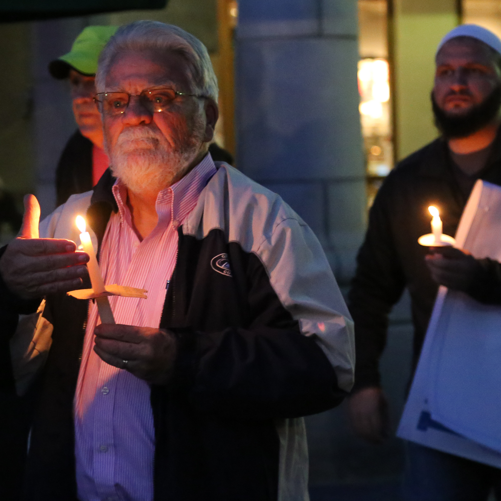 Participants (in the foreground) and Imam Fayaz Nawabi (in the background) walking towards an interfaith candlelight vigil that honored the memory of the victims of San Bernardino massacre. The event was hosted by the Christ Presbyterian Church of Carlsbad, the Jewish Collaborative of San Diego and the the North County Islamic Foundation. Dec. 8, 2015 in Carlsbad. Photo by Lou Roubitchek / Jewish Collaborative of San Diego