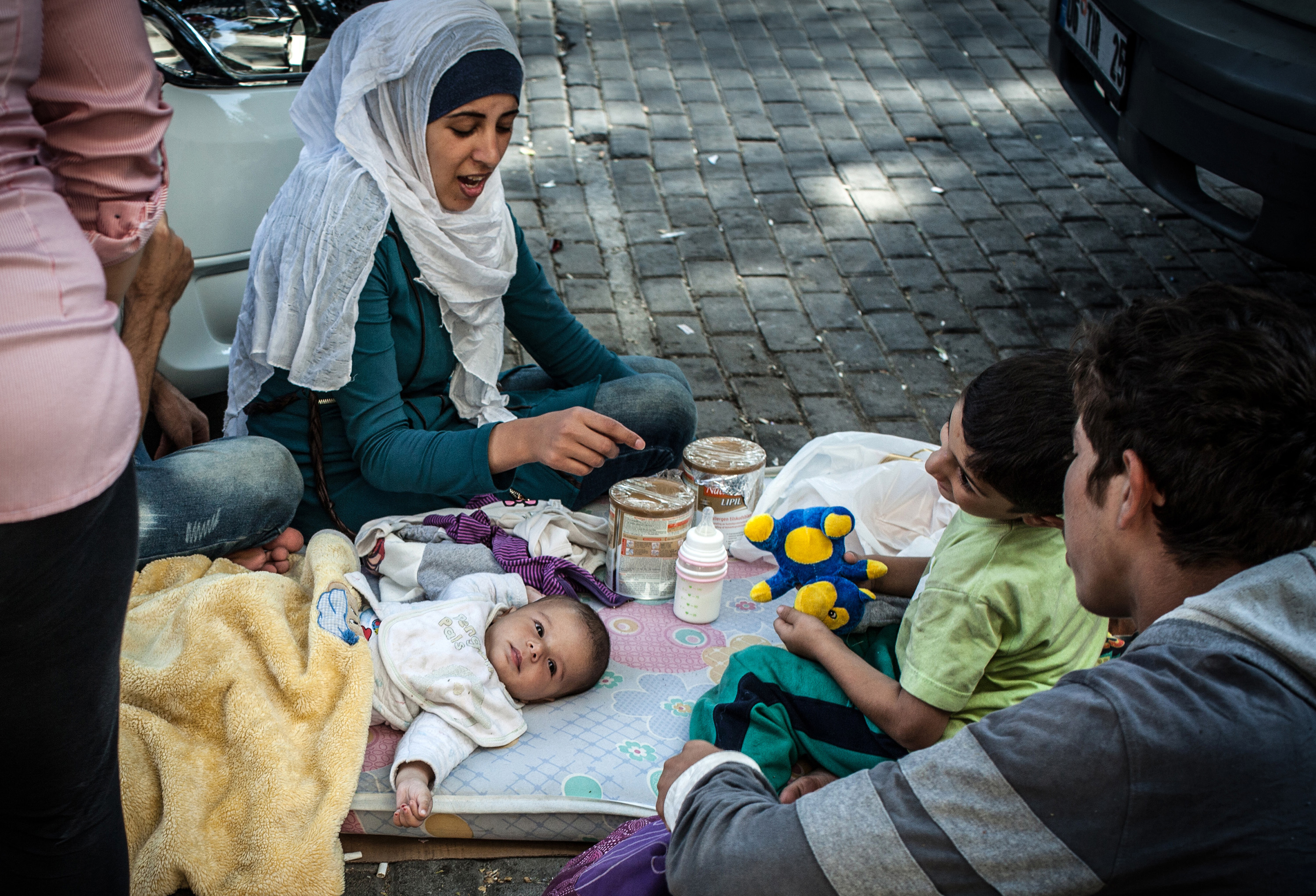A Syrian family stays on the street where they have been sleeping in Izmir, Turkey, while they attempt to reach Greece by boat on Sept. 3, 2015. Photo courtesy of Tribune News Service.