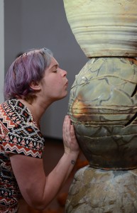Gallery attendee Michelle Hauswirth blows into ceramic artist Jessica Rae Thompson's sculpture thereby creating a whistle sound during the Ceramics Biennial at the Palomar College Boehm Gallery on Feb. 18. Tracy Grassel/The Telescope