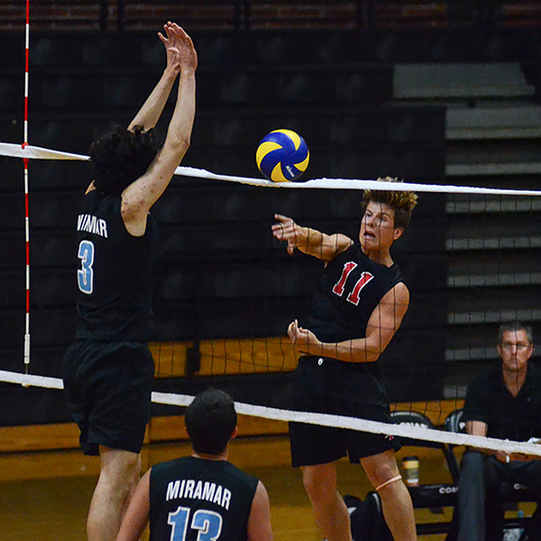Palomar College outside hitter Tyler Hedley (11) spikes the ball past Anthony Carrasco (3) in the first match against Miramar College on March 2 at the Dome. Palomar won 3-0. Tracy Grassel/The Telescope