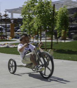 ECE student (name left blank until confirmation comes in with go ahead to release it) rides a tricycle around the playground as fast as he can during recess on Monday May 9 at the Early Childhood Education Lab School on Palomar's San Marcos Campus. Tracy Grassel/The Telescope