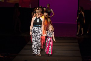 Fashion designer, Renetta Lloyd (right) walks down the runway accompanied by her young daughter and the models who donned her designs during this year's MODA Fashion Show, which took place on May 6 at the California Center for the Arts, Escondido. Claudia Rodriguez/The Telescope