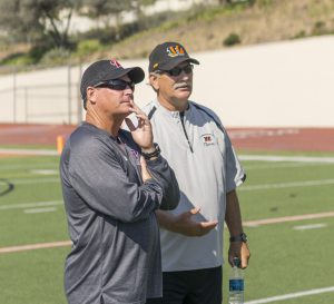 Palomar coach Joe Early (left) and Riverside City College coach Tom Craft (right) (Craft was head coach of the Comets from 1983-2000) watch as their teams go through warm-ups prior to the scrimmage. The Comets hosted the visiting Tigers in a scrimmage held Aug 27 at Wilson Stadium in Escondido High School. The Comets open the season at home on Sept 3 at 6pm in a non-conference game against Southwestern.