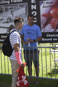 Palomar freshman Andres Bojorquez discusses abortion rights with Stephen Beatty, a volunteer with the Center for Bio-Ethical Reform, in the Student Union grass on Sept 14, 2016. Eric Szaras/The Telescope